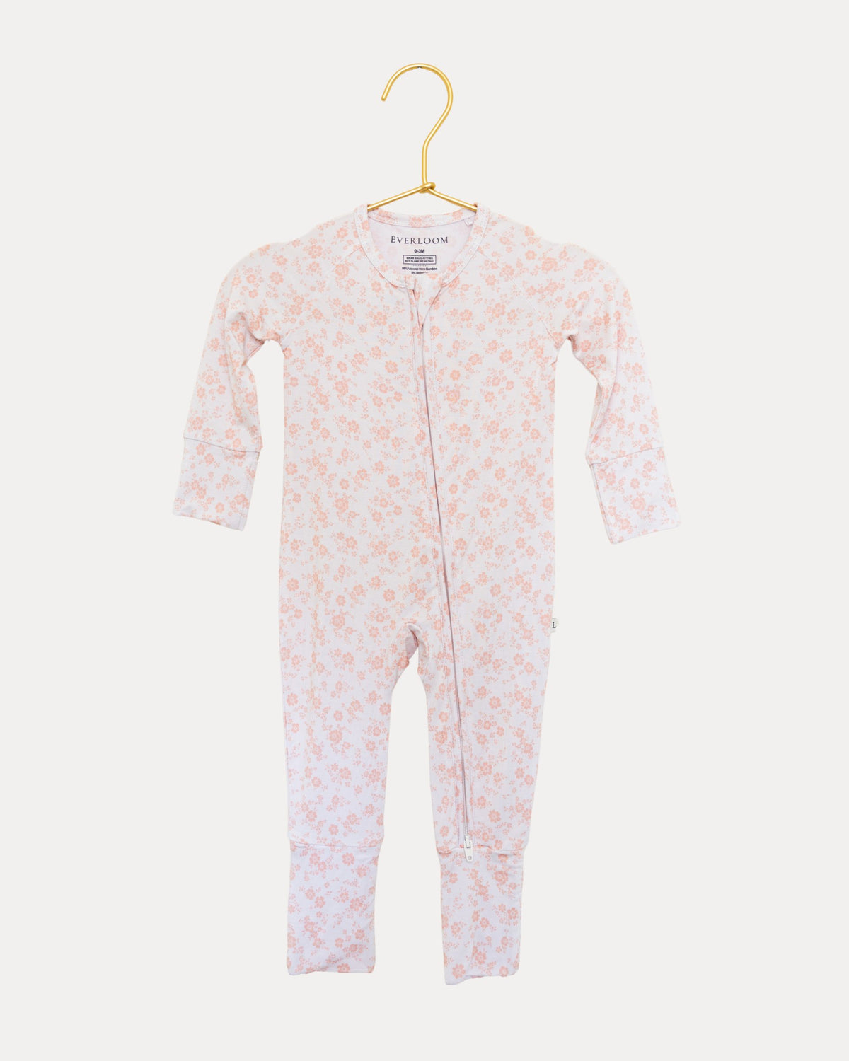Blush Blossoms bamboo zip sleeper on a hanger, soft pink floral print