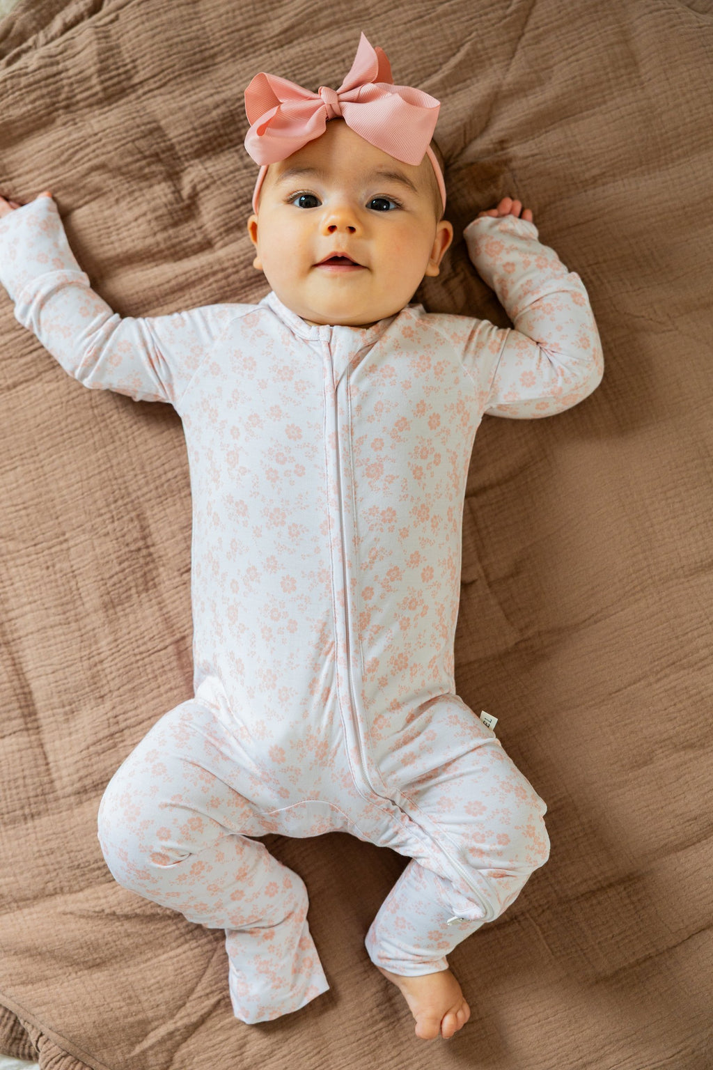 Baby in the footed Blush Blossoms sleeper, full length