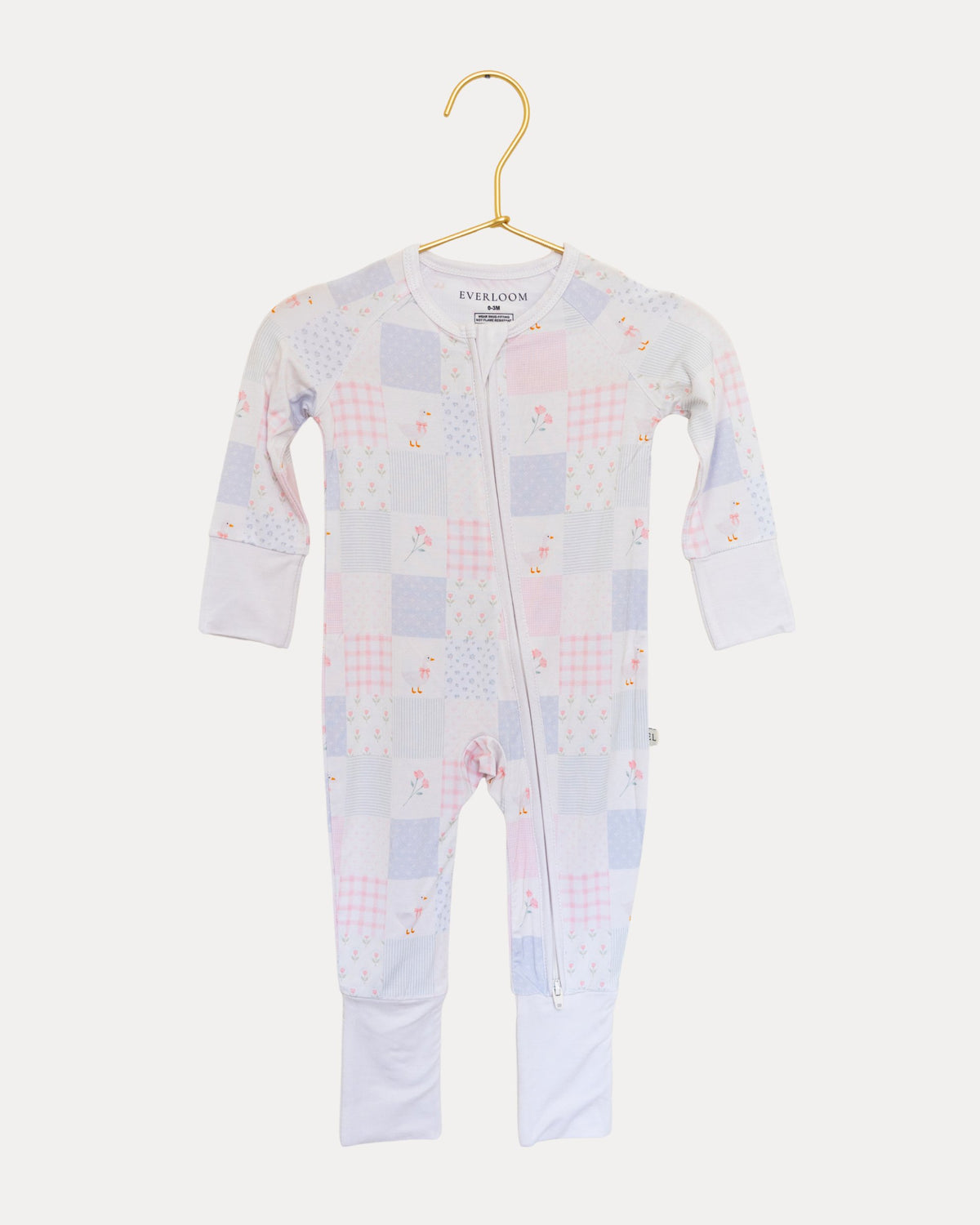 Heirloom Quilt bamboo zip sleeper on a hanger, soft pink and blue patchwork print