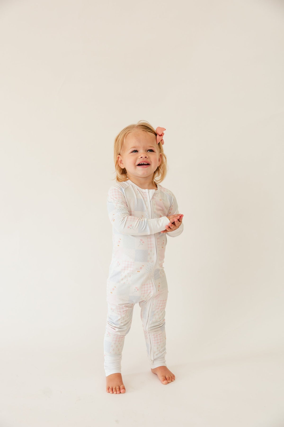 Toddler standing in the Heirloom Quilt bamboo zip sleeper