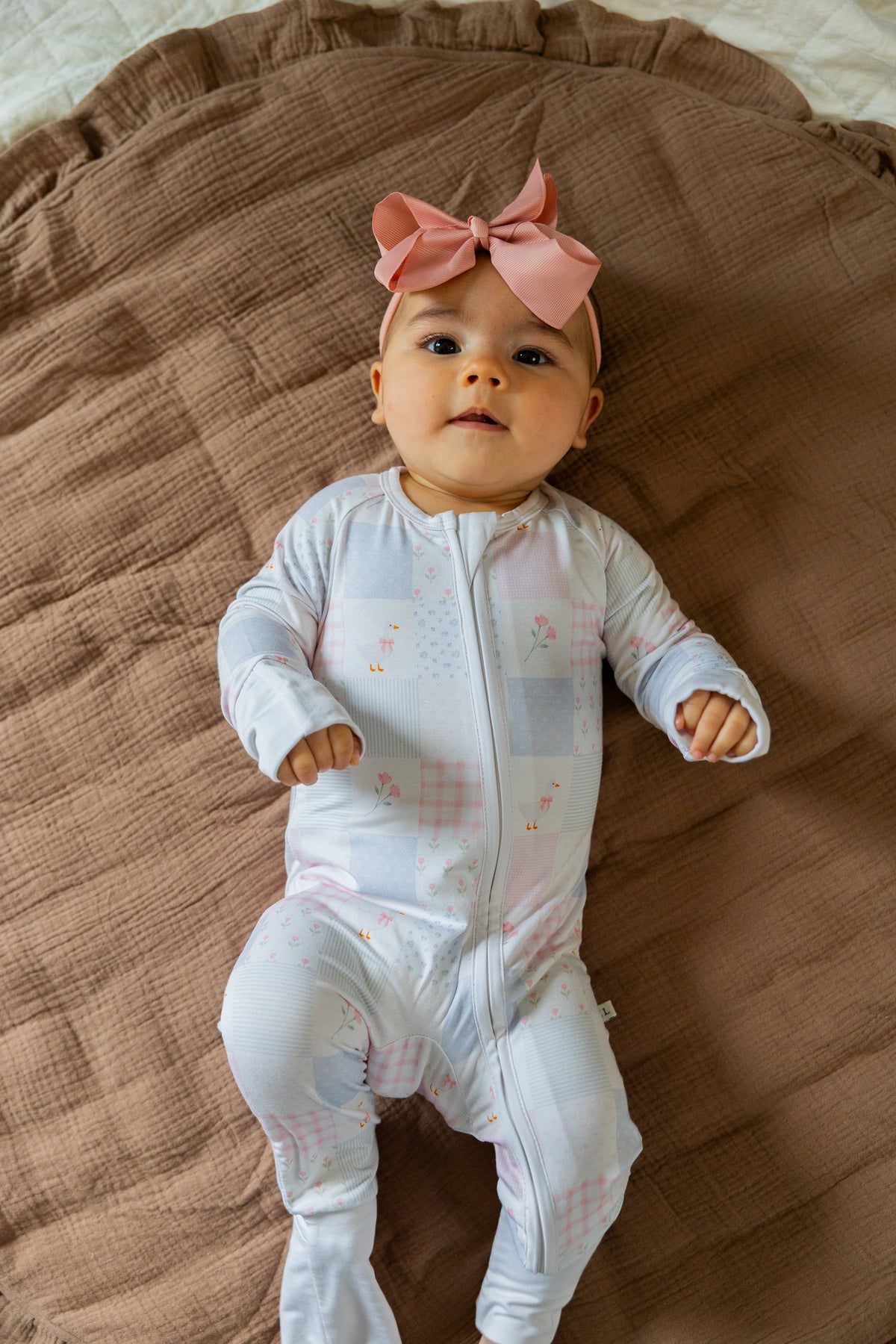 Baby in the footed Heirloom Quilt sleeper, full length