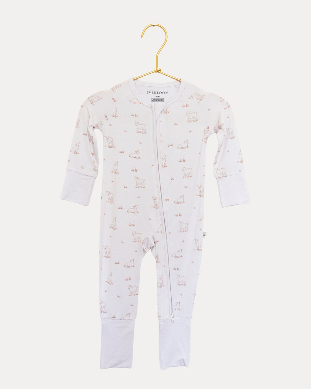 Little Lamb bamboo zip sleeper on a hanger, tiny lambs on a warm neutral base