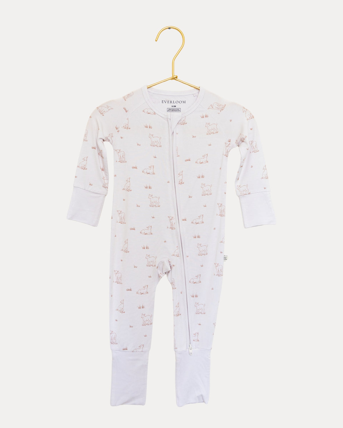 Little Lamb bamboo zip sleeper on a hanger, tiny lambs on a warm neutral base