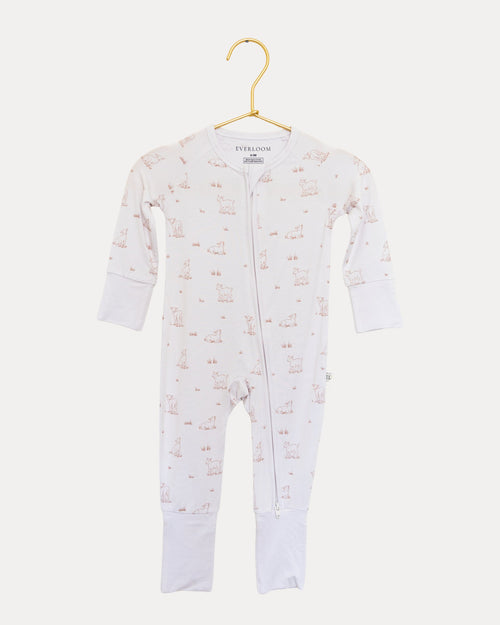 Little Lamb bamboo zip sleeper on a hanger, tiny lambs on a warm neutral base