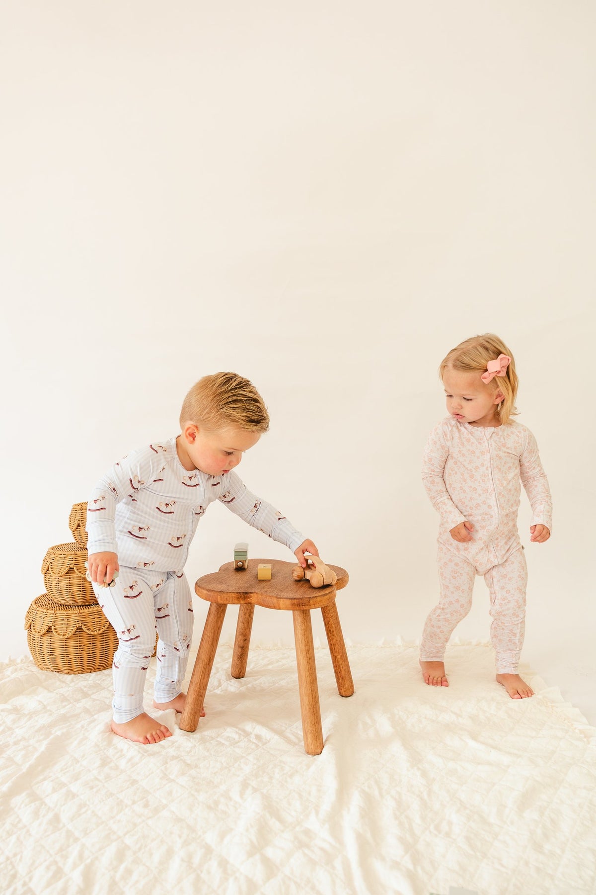 Two toddlers playing together in Everloom sleepers