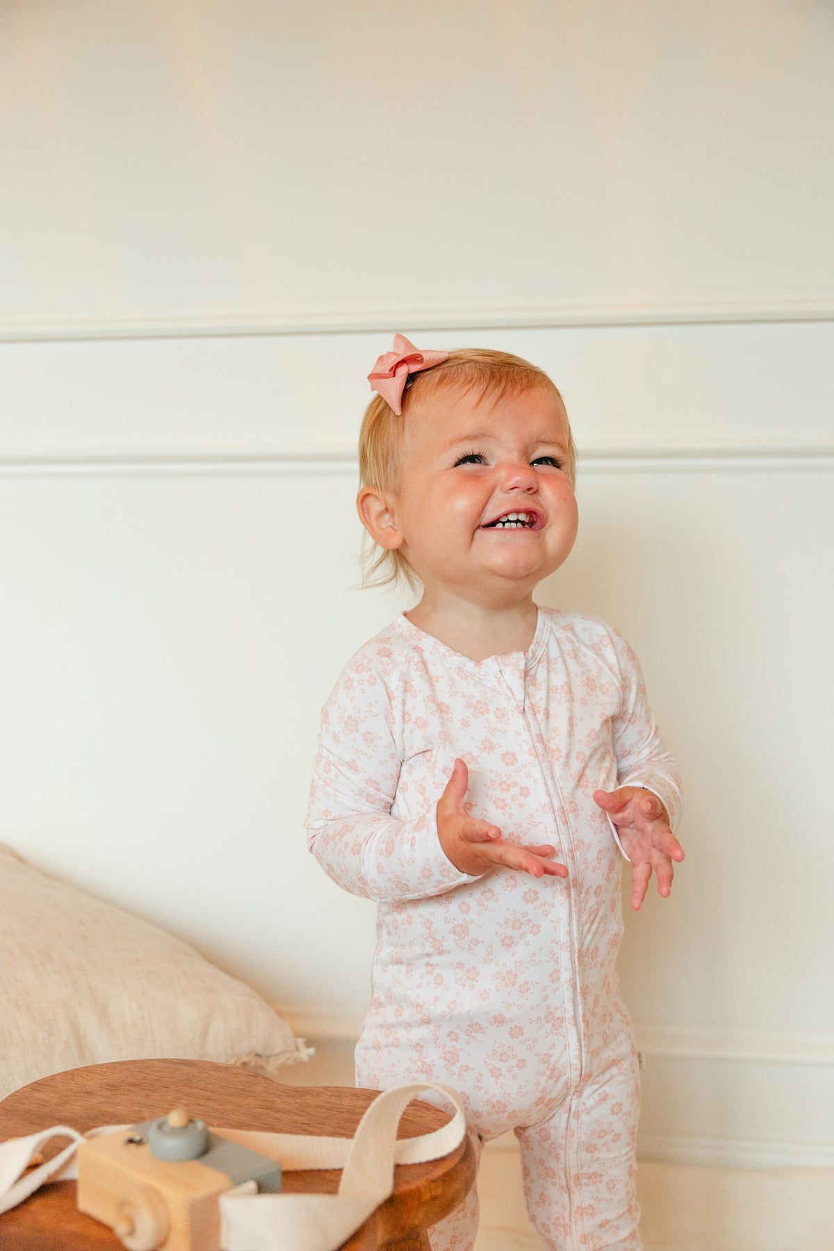 Smiling toddler in the Blush Blossoms sleeper