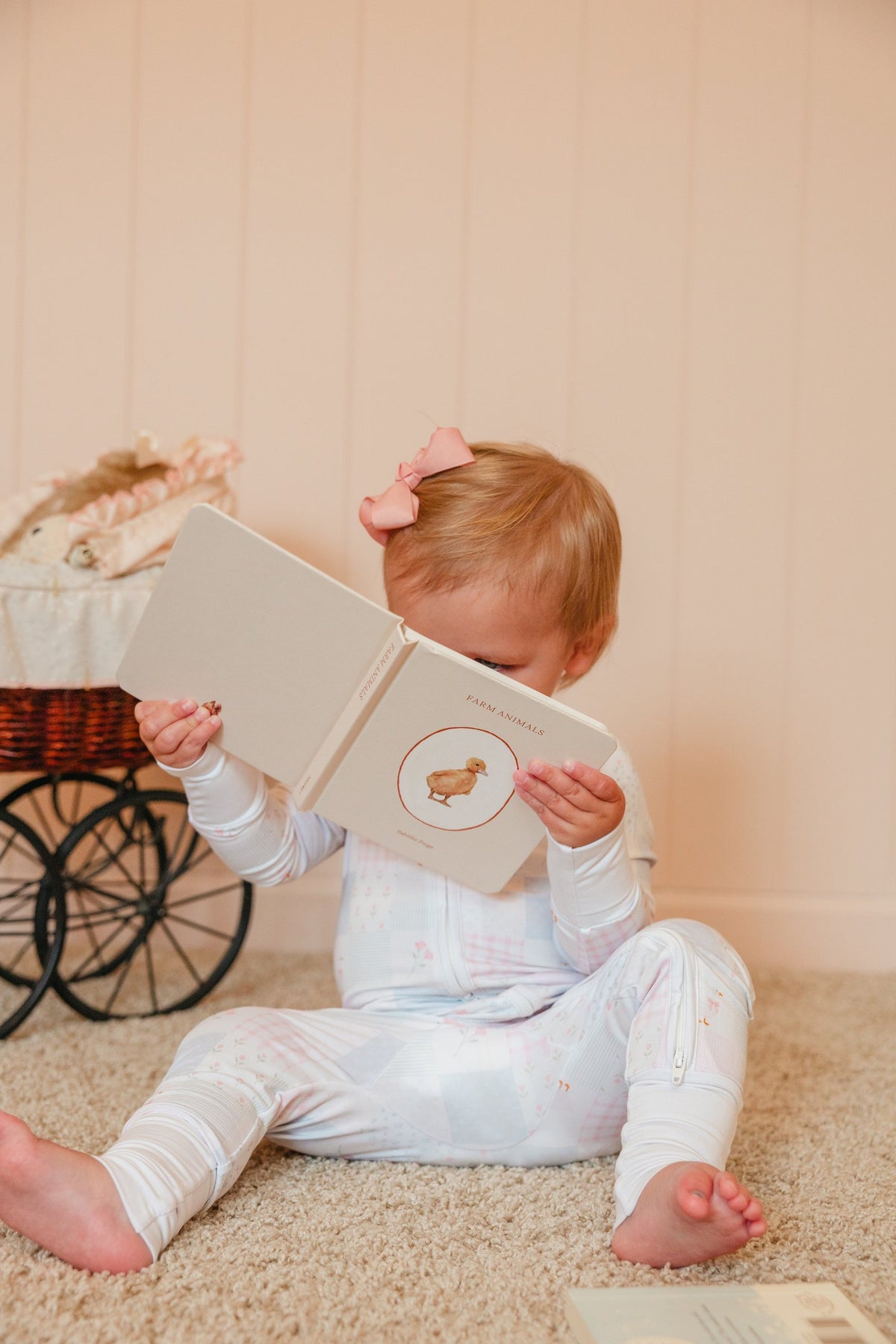 Toddler reading a board book in an Everloom sleeper